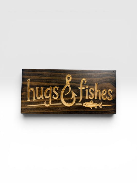 Hugs & Fishes wood sign with fishing hook ampersand, carved fish, natural wood lettering, and Kona dark brown finish by CARVEDN.