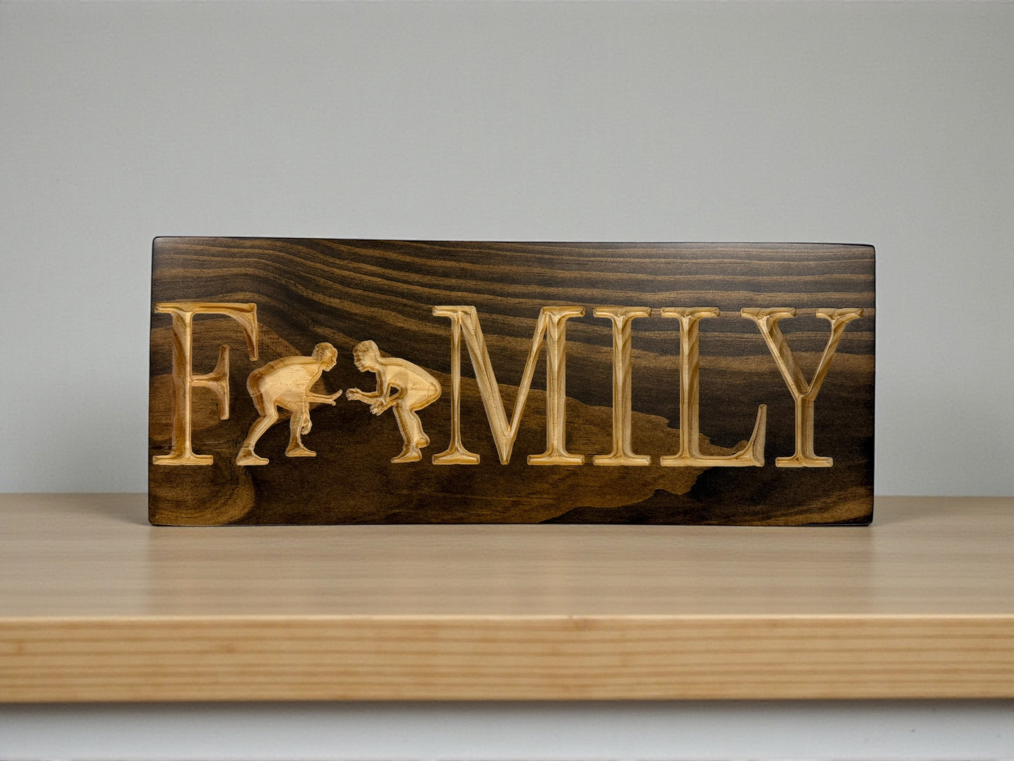 Carved Wrestling Family wood sign in Kona stain with natural lettering and wrestler figures, 7 x 18 rustic sports decor by CARVEDN